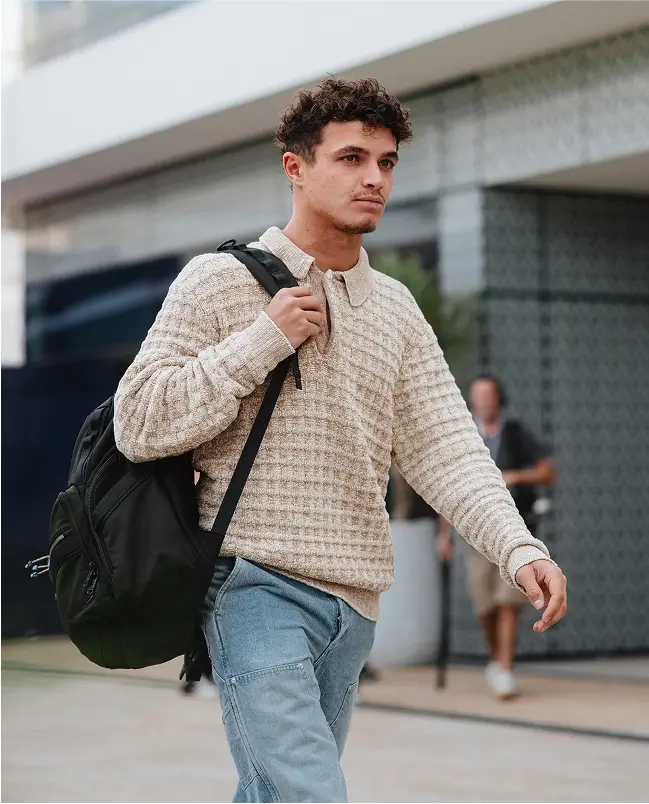 Nexter in casual clothes walking through paddock